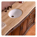 Elegant wooden bathroom vanity with curved edges, marble countertop, white undermount sink, and bronze fixtures.