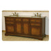 Antique wooden bathroom vanity with marble top, double sinks, and ornate brass faucets, featuring rich wood tones and decorative panels.