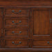 Rich mahogany wooden dresser with four drawers and a side cabinet, featuring antique bronze drawer pulls.