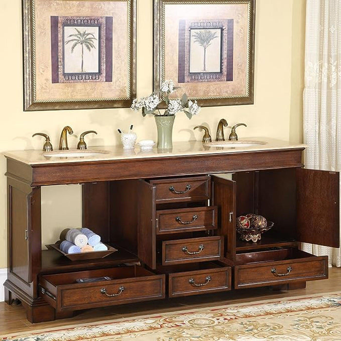 Elegant wooden bathroom vanity with marble top, double sinks, open drawers, and palm tree artwork framed on wall.