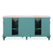 Turquoise bathroom vanity with white marble top, featuring two sinks and open storage shelves on ornate legs.
