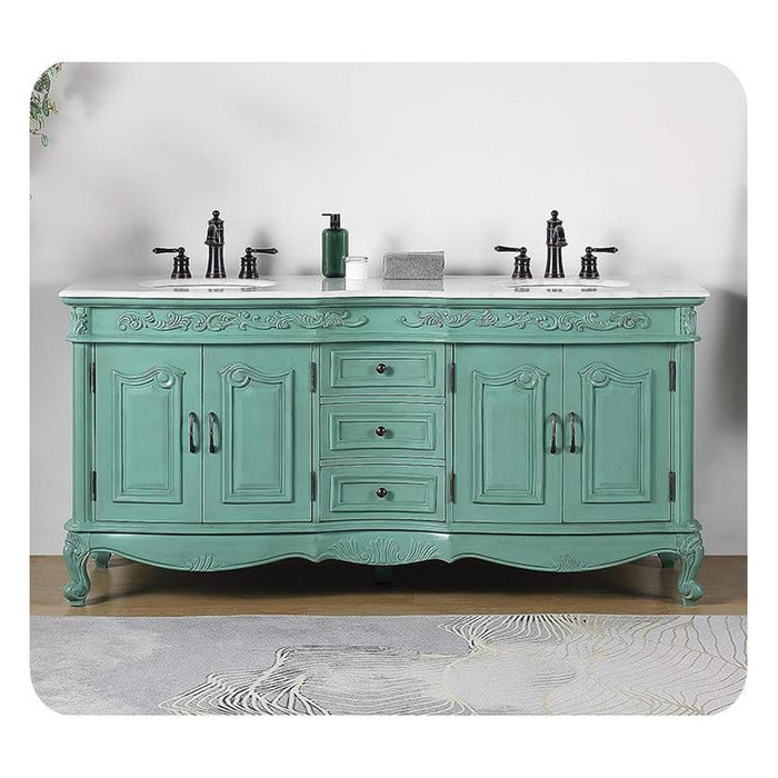 Vintage-style seafoam green double vanity with ornate details, white marble top, and black fixtures
