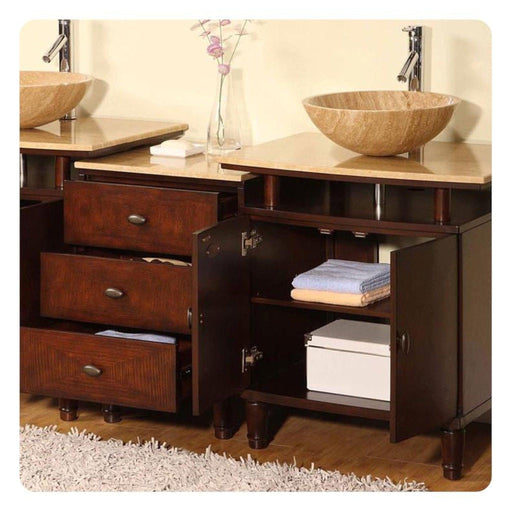 Dark wood bathroom vanity with stone vessel sinks, drawers open, folded towels, and pink flower vase.