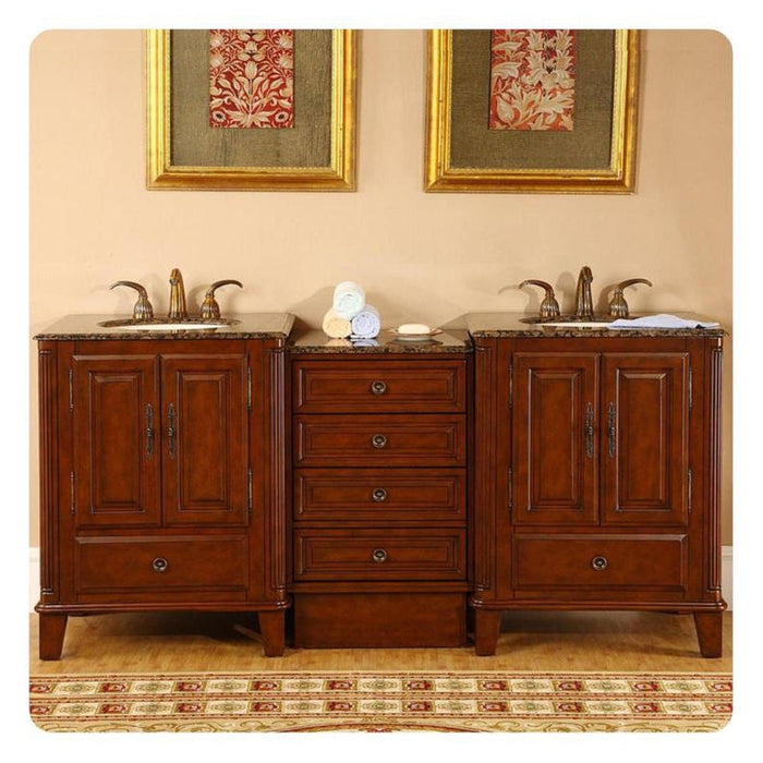Elegant wooden bathroom vanity with double sinks, granite countertops, and decorative red floral artwork in gold frames above.