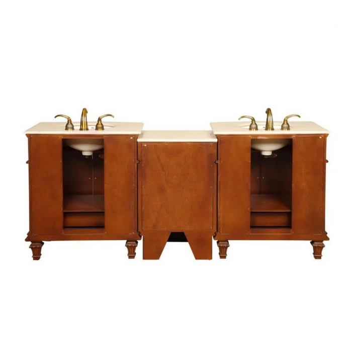 Wooden bathroom vanity with three sections, two sinks, marble countertop, and brass faucets on elegant carved base.