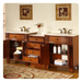 Elegant wooden bathroom vanity with double sinks, decorative drawers, floral wall art, and neatly folded towels on open shelves.
