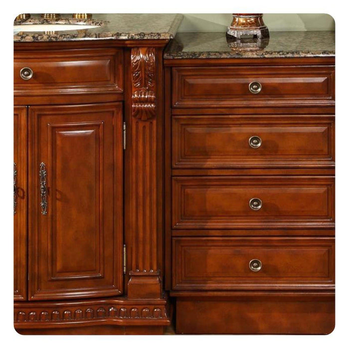 Rich cherry wood kitchen cabinetry with ornate carved details, marble countertop, and decorative bronze hardware