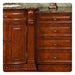 Rich cherry wood kitchen cabinetry with ornate carved details, marble countertop, and decorative bronze hardware