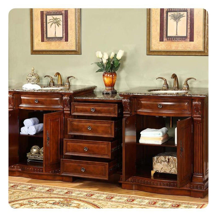 Elegant wood bathroom vanity with marble top, drawers, white towels, and palm tree artwork in gold frames.