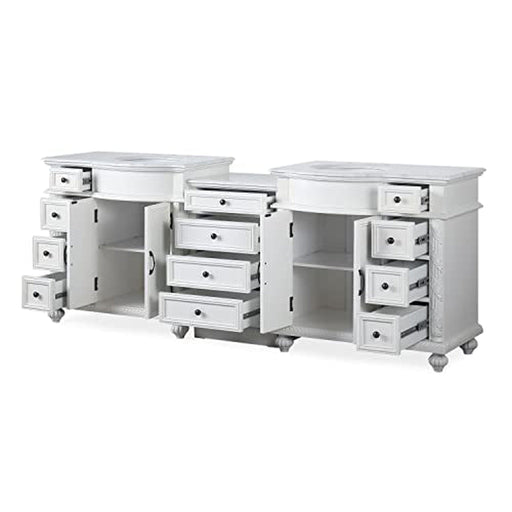 White bathroom vanity with multiple drawers open, revealing storage compartments and clean design aesthetic.