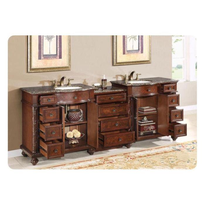 Luxurious wooden bathroom vanity with marble top, multiple drawers, two sinks, and decorative details on ornate patterned rug.