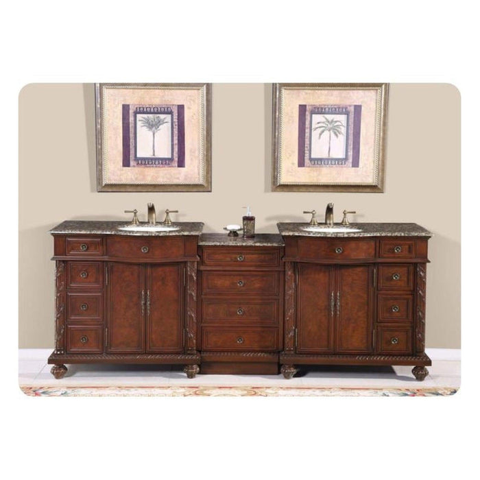 Elegant wooden double bathroom vanity with granite countertops, two sinks, and palm tree art above, mounted on ornate rug.