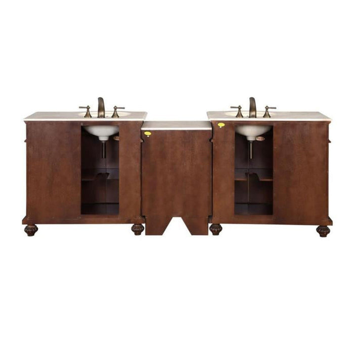 Double sink bathroom vanity with wood cabinets, white marble top, and bronze faucets on elegant turned legs.
