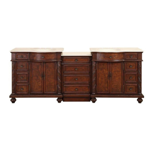 Antique wooden double vanity with rich brown finish, marble top, ornate drawers, and decorative column details between two cabinets.