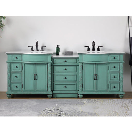 Vintage-style mint green double vanity with white countertops, black fixtures, and multiple drawers and cabinets.