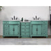 Vintage-style mint green double vanity with white countertops, black fixtures, and multiple drawers and cabinets.