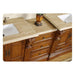 Ornate wooden bathroom vanity with carved details, marble countertop, white sink, and decorative vase.