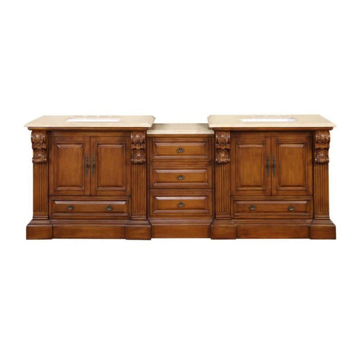 Ornate wooden bathroom vanity with three sections, carved columns, cream marble top, and multiple drawers and cabinets.