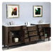 Dark wood bathroom vanity with marble top, two sinks, and multiple drawers, accented by abstract framed art in textured frames.
