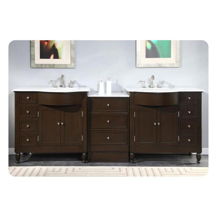 Dark wood double vanity with white marble top, two sinks, and framed art on light gray wall.