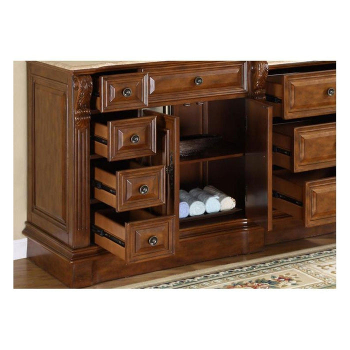 Rich wood bathroom vanity with multiple open drawers, revealing rolled white towels in a center cabinet compartment.