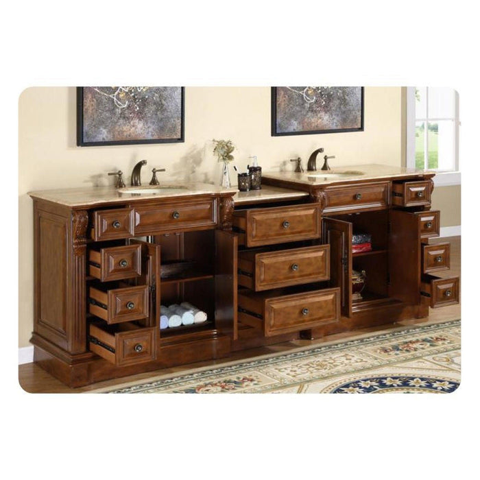 Luxurious wooden bathroom vanity with multiple drawers open, revealing storage space and rolled towels, with dual sinks and decorative artwork.