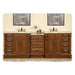 Elegant wooden double bathroom vanity with rich brown finish, two sinks, decorative artwork, and center drawers on patterned rug.