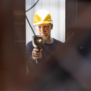 Teledyne FLIR E5 Pro person using camera inspection hard hat.