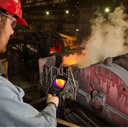 Teledyne FLIR E76 14 person using thermal camera in industrial furnace environment.