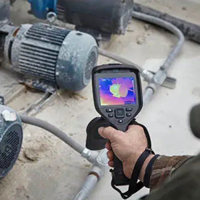 Teledyne FLIR E86 Dual FOV 24 42 inspecting industrial motor with handheld thermal camera.