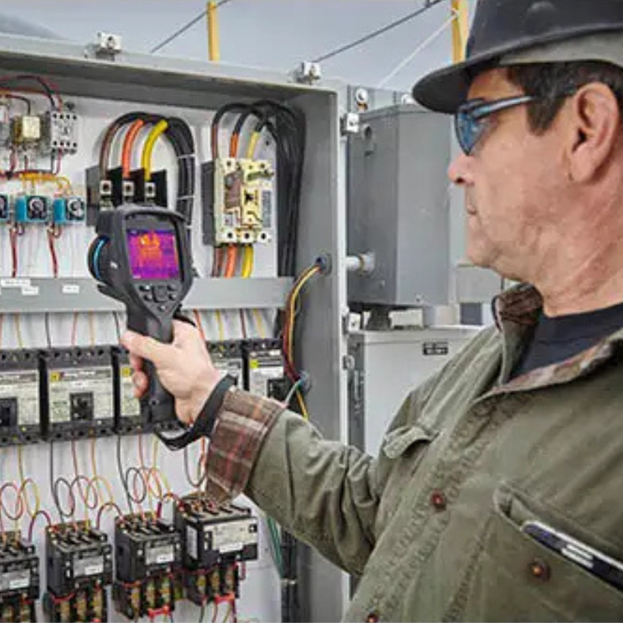Teledyne FLIR E86 Dual FOV 24 42 technician using thermal imager on electrical panel.