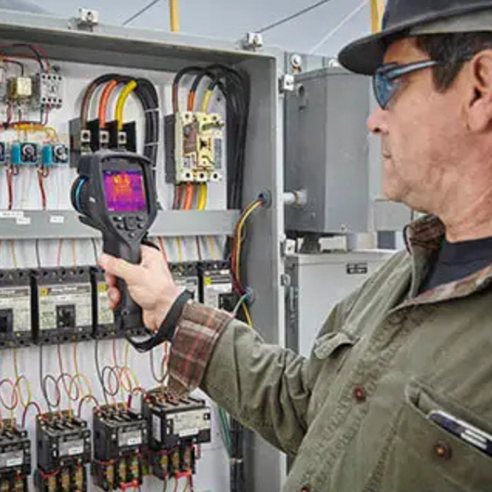 Teledyne FLIR E86 electrical panel inspection man using camera on wiring.