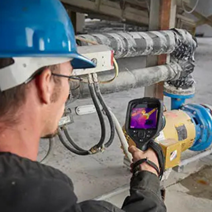 Teledyne FLIR E96 24 42 technician using thermal camera on industrial equipment