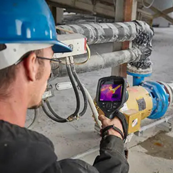 Teledyne FLIR E96 Dual FOV 24 42 14 30Hz 640x480 technician using device on industrial pipes.
