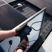 Teledyne FLIR PV48 user holding device outdoor solar panel testing.