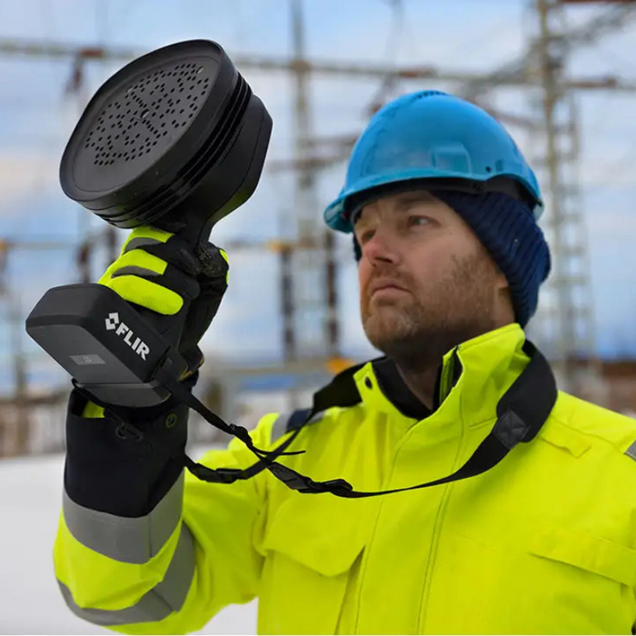 Teledyne FLIR Si2 PD person using device hardhat hi vis jacket industrial environment.