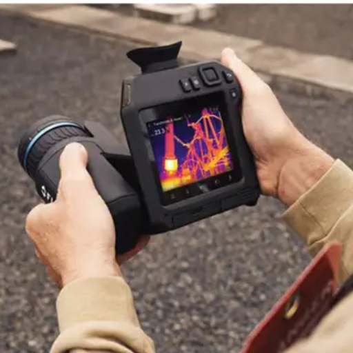 Teledyne FLIR T865 24 14 angled view hands holding camera screen showing thermal reading.
