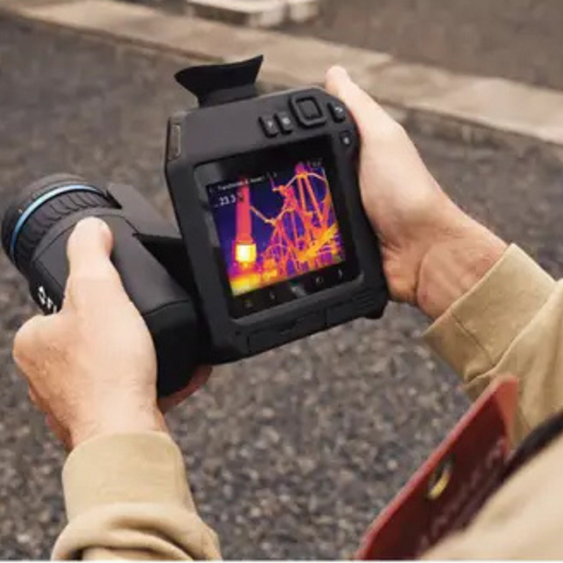 Teledyne FLIR T865 DFOV 24 42 hands holding device thermal display outdoor scene.