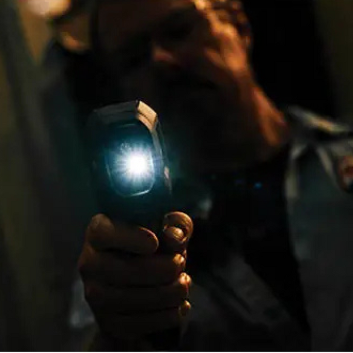 Teledyne FLIR TG165 X dark environment flashlight activated held by technician.