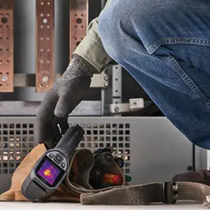 Teledyne FLIR TG165 X worker retrieving thermal camera from tool bag.