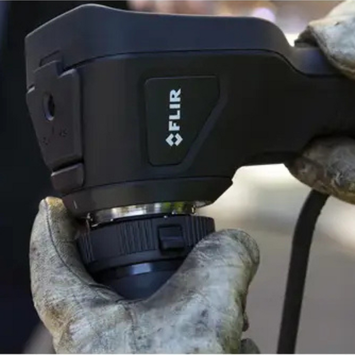 Teledyne FLIR VS290 32 closeup hand adjusting detachable lens on device.