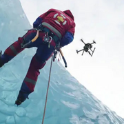 Teledyne FLIR VUE TZ20 60HZ upward view rescue worker ice wall drone hovering.