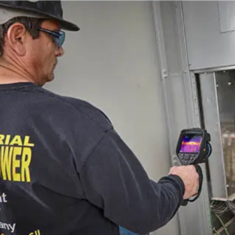 Teledyne Flir E76 24 technician using thermal camera on electrical panel.