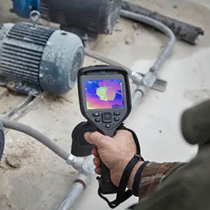 Teledyne Flir E86 24 42 handheld view thermal camera inspecting industrial motor.