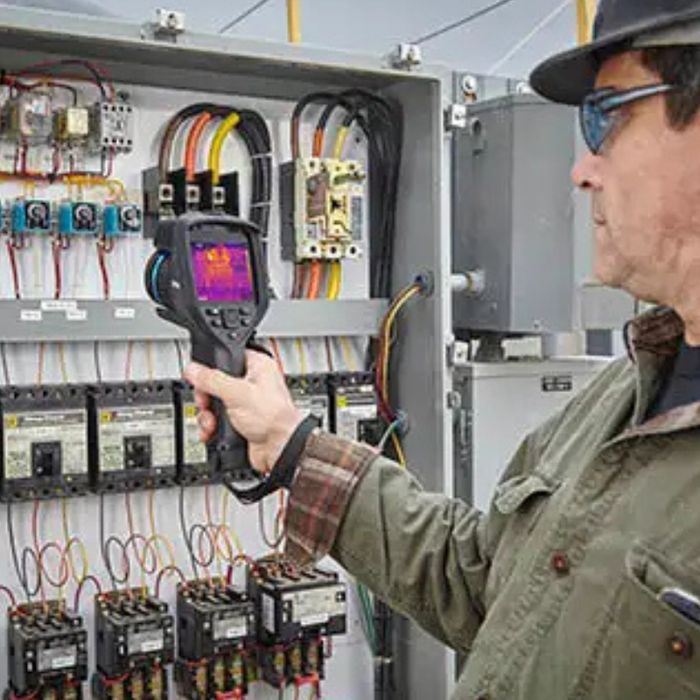 Teledyne Flir E86 thermal camera used by technician electrical panel inspection.