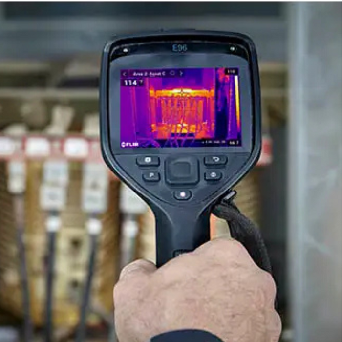Teledyne Flir E96 close up back view hand holding camera thermal reading.