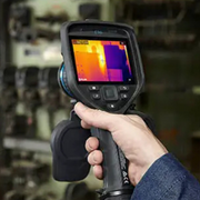 Teledyne Flir E96 hand holding camera thermal reading on equipment.