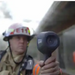 Teledyne Flir K65 firefighter holding thermal camera front view.