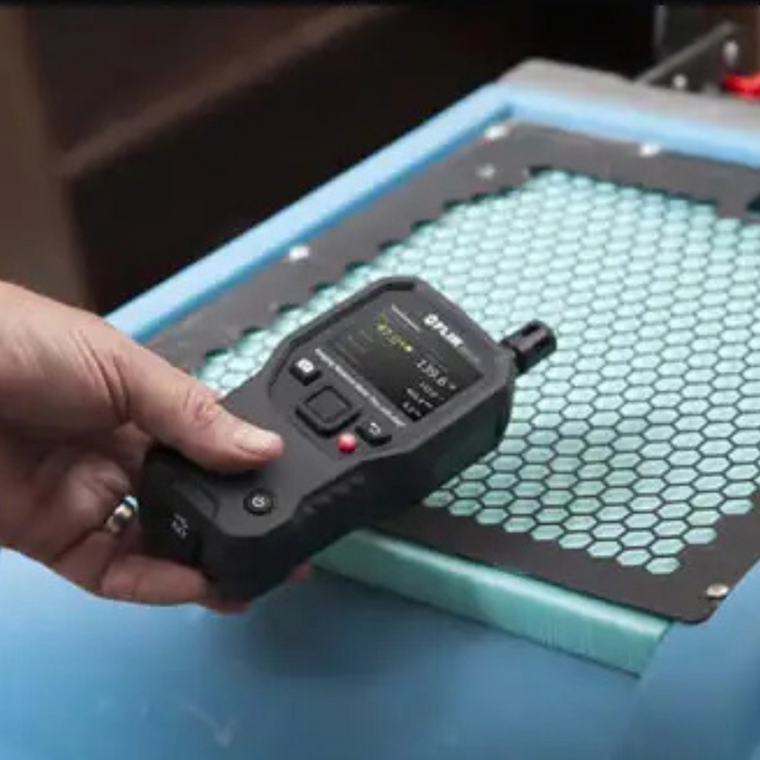 Teledyne Flir Mr176 Kit5 hand holding device over honeycomb surface.