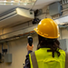 Teledyne Flir Sv89 Remote Vibration Temperature Sensor worker using sensor on ceiling vent yellow hard hat.